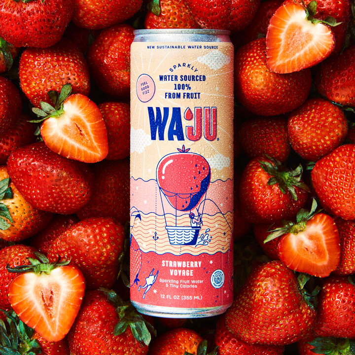 Sparkling strawberry water can against sliced fruit strawberries